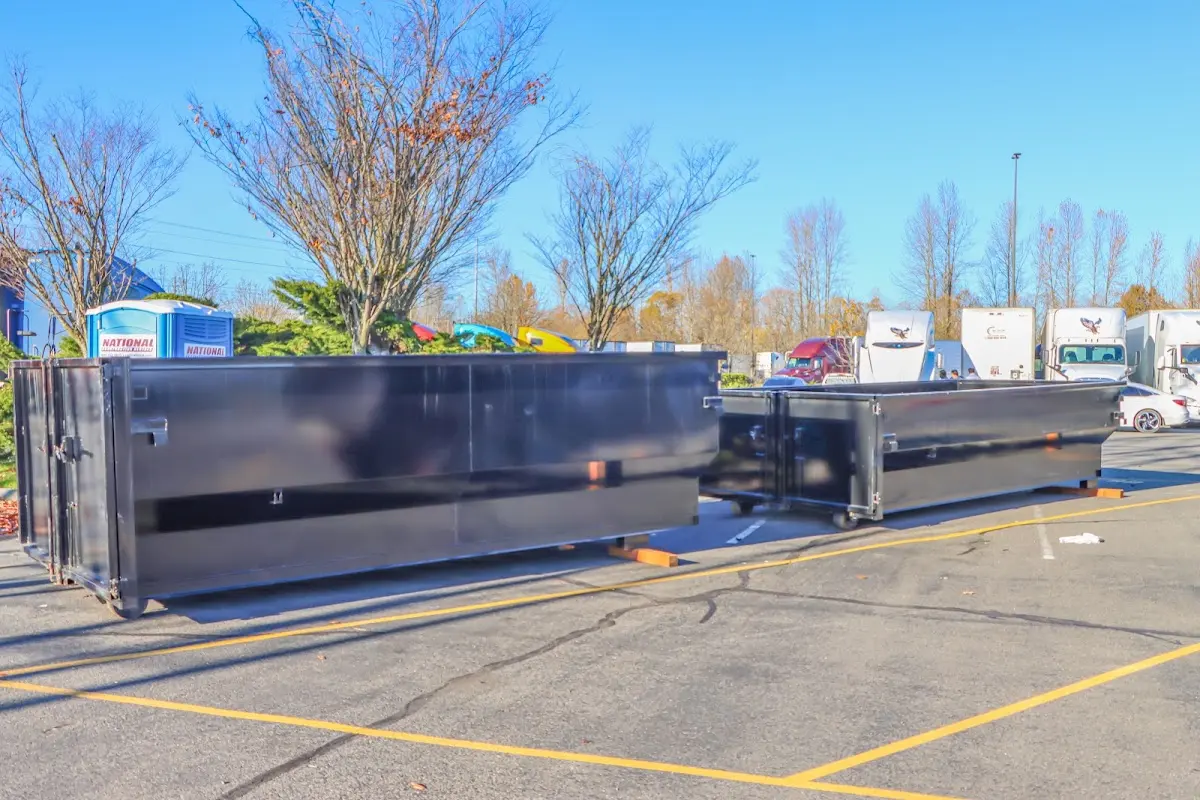 Professional dumpster rental service with roll-off container on residential driveway in Lewistown